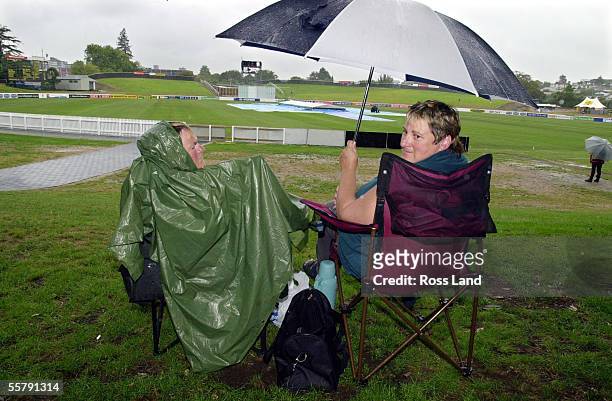 Hardy cricket fans, Charmain Kirk and Sharon Woods, both from Hawera in Taranaki, wait for play to start in the rain delayed second day of the third...