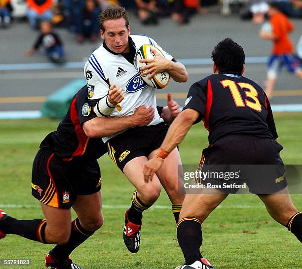 Hurricanes Brent Ward is caught between Chiefs Loki Crichton, left and Keith Lowen in a pre season Super 12 Rugby game at the Levin Domain, Friday.