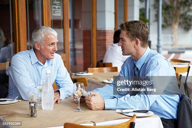 businessmen talking at restaurant - café esplanada imagens e fotografias de stock