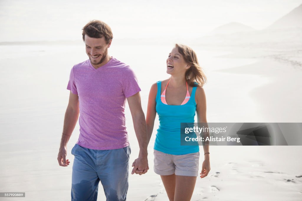 Couple walking together on beach