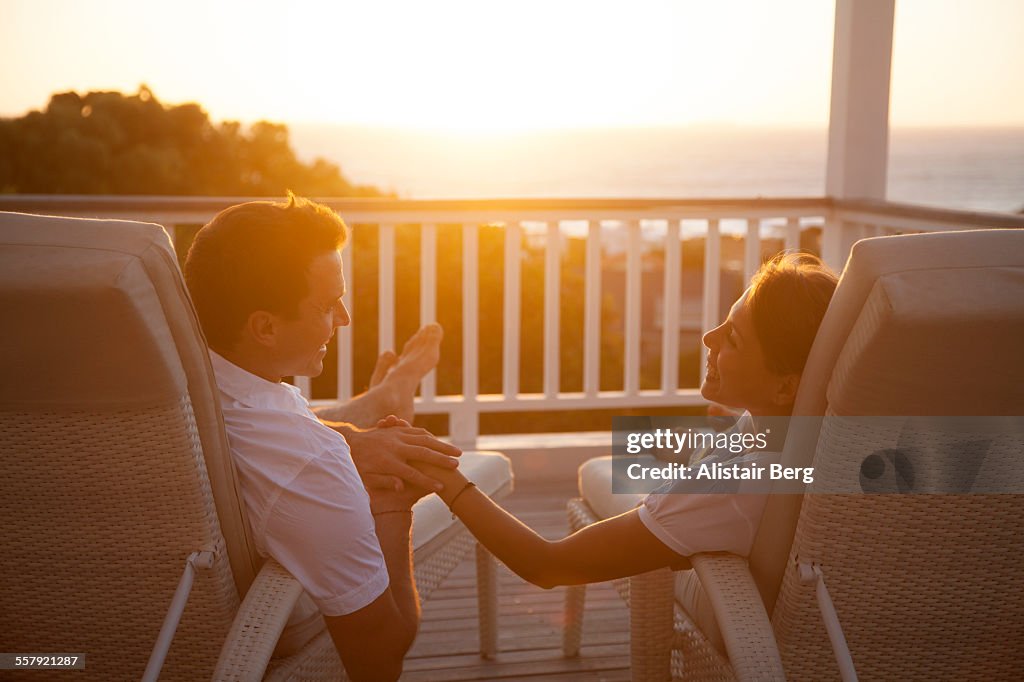 Couple holding hands at sunset