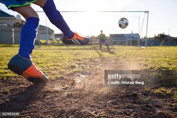 close up of boy taking soccer penalty - calciare foto e immagini stock