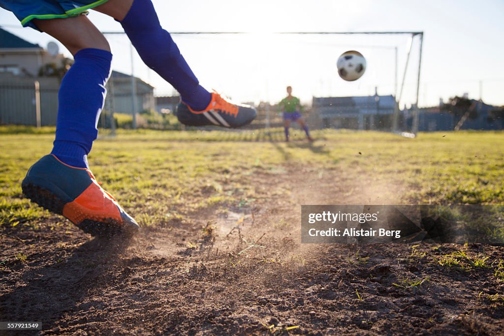 Close up of boy taking soccer penalty