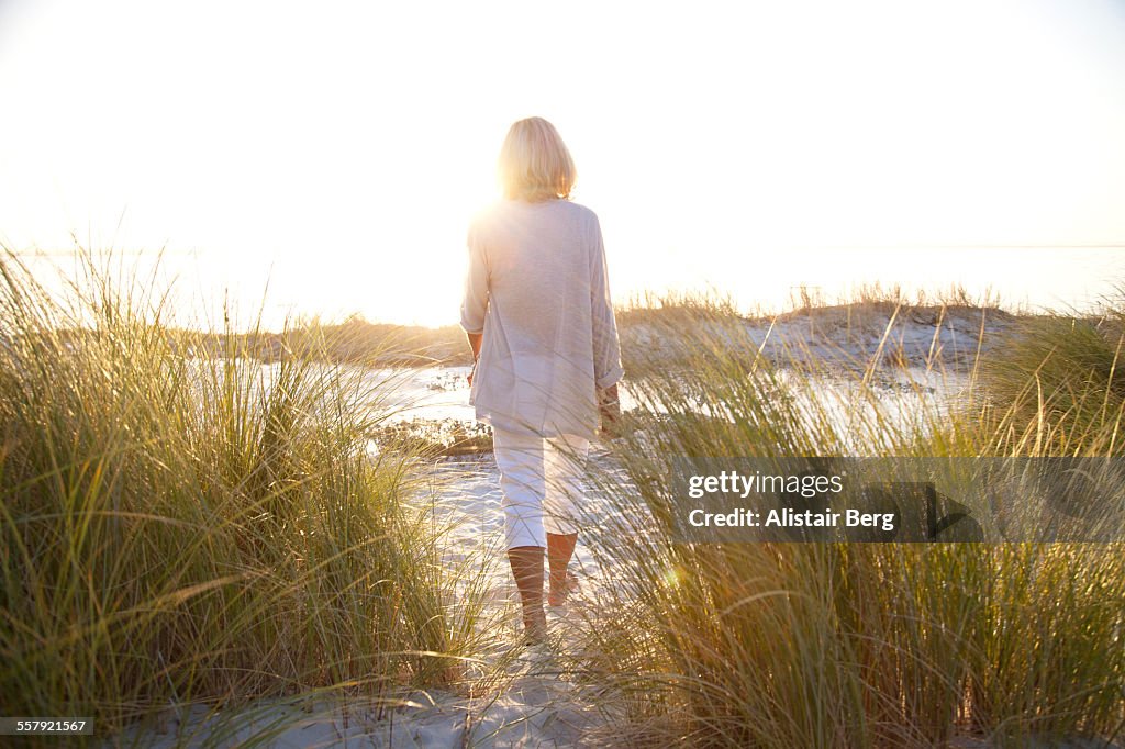 Senior woman walking on beach