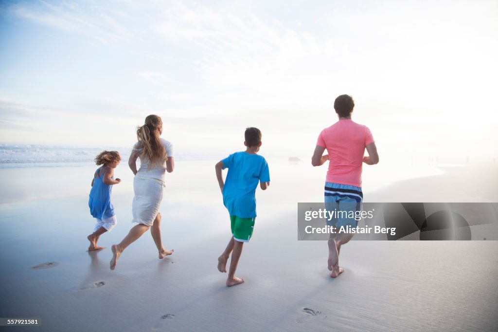 Family running together on beach