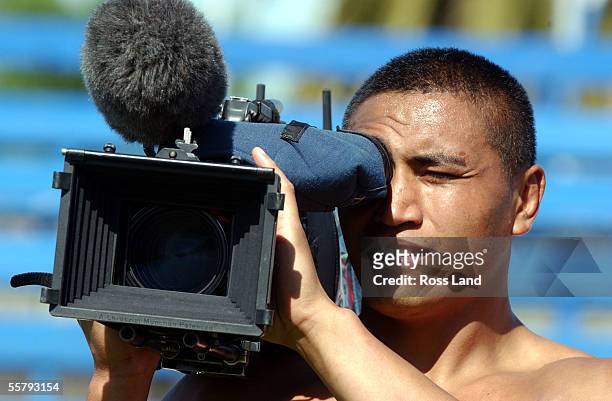 Jerry Collins tries a Telvision camera out following training at Bob Jane Stadium in Melbourne two days after the All Blacks 1022 loss to the...