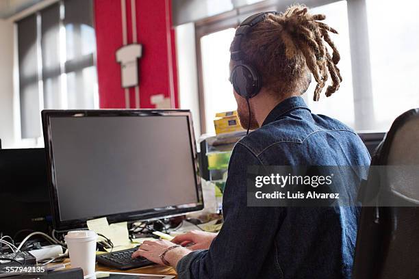 entrepreneur using desktop pc in start-up office - dreadlocks back stock pictures, royalty-free photos & images