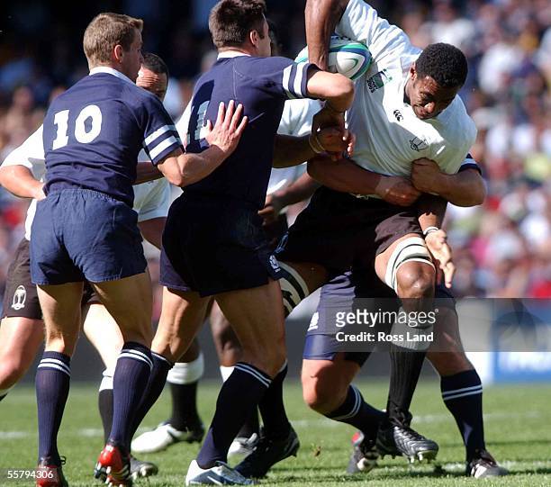 Lock Ifereimi Rawaqa breaks through the Scotish defence of Chris Paterson and Kenny Logan during the Rugby World Cup 2003 Pool B clash between Fiji...