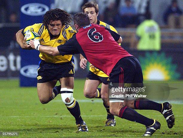 Hurricanes Rodney So'oialo fends off Crusaders Reuben Thorne during their Super 12 semifinal rugby match played at Jade Stadium, Friday. The...