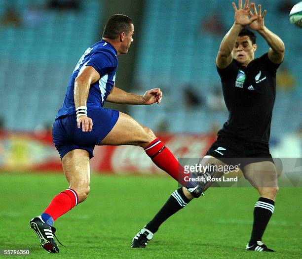 New Zealand born French player Tony Marsh chips the ball over the head of Daniel Carter during the All Blacks 4013 win over France in their Rugby...
