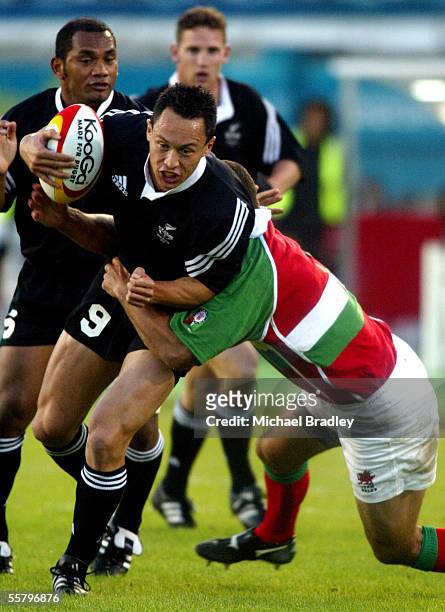 New Zealand sevens player Bruce Raihana is tackled by the Welsh defence, during the Rugby sevens quater final between New Zealand and Wales held at...