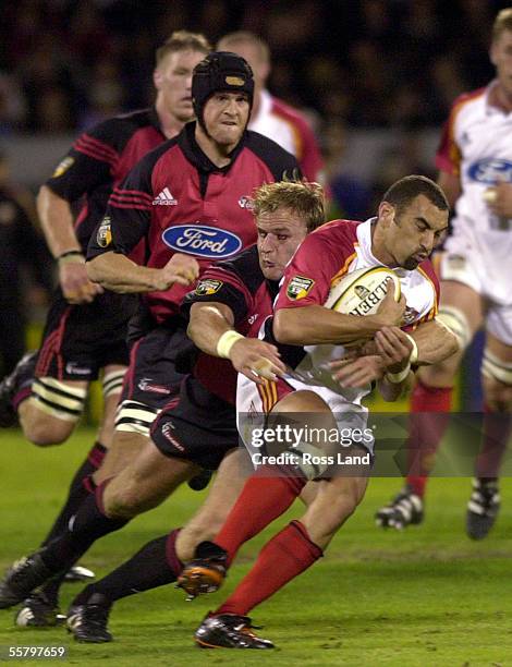 Roger Randle, tackled by Scott Robertson, during the Crusaders V Chiefs Super12 rugby clash at Jade Stadium, Christchurch, Saturday. Crusaders 40,...