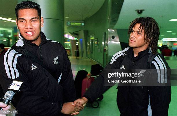 All Blacks, Bradley Mika and Rodney So'oalio shake hands as they talk to the media after arriving back at the Auckland International Airport, as the...