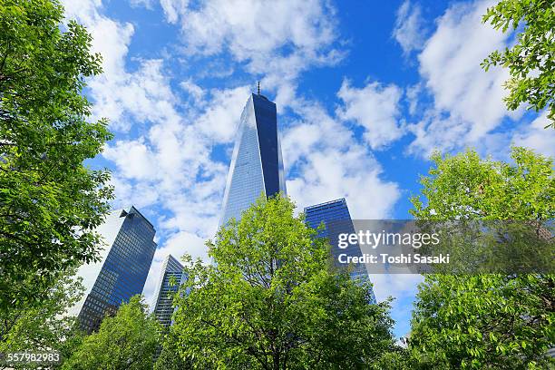 clouds above freedom tower and fresh green trees - one world trade center stock pictures, royalty-free photos & images