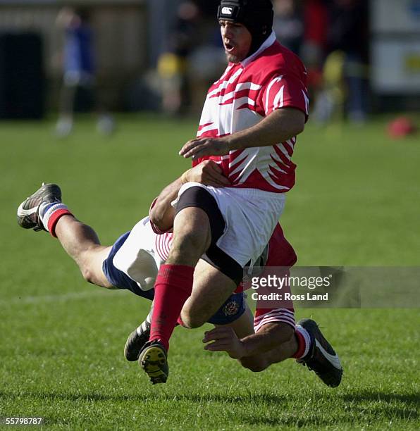 Poverty Bay centre Willie Lardelli is taken late by the HorowhenuaKapiti defence, during the Air New Zealand NPC third division rugby match won 3018...