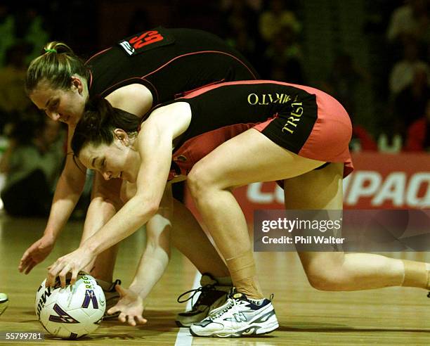 Waikato's Leigh Price scoops up the ball with Canterbury's Katie Ritchie in their NPC Womens netball final played at Mystery Creek, Saturday. Waikato...