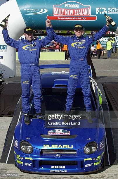 Richard Burns , right and codriver Robert Reid on the bonett of their Subaru Impreza WRC 2001 after finishing first overall in the Propeciel 2001...
