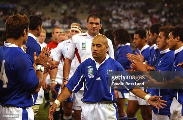 Samoan fullback tanner Vili walks off aheads of a dejected England captain Martin Johnson, following his sides 3522 loss to England in their sides...