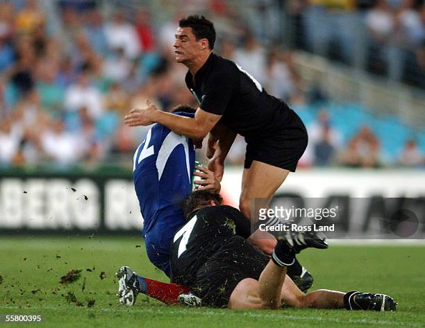 Richie McCaw and Daniel Carter combine to tackle Damien Trailee during the All Blacks 4013 win over France in their Rugby World Cup 2003 third and...