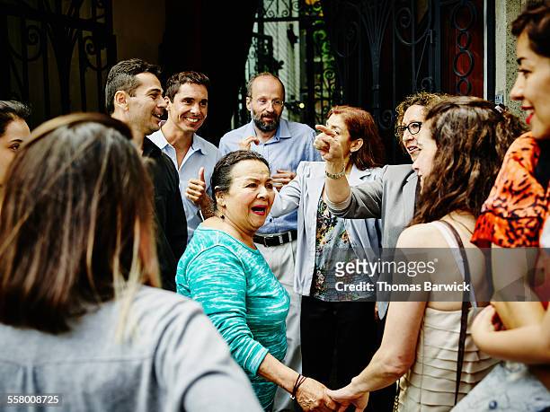 multi-generational family greeting each other - large group of people outside stock pictures, royalty-free photos & images