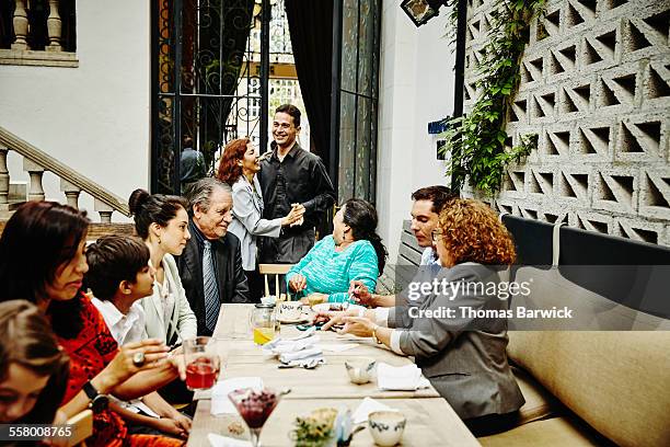couple dancing in restaurant during dinner party - senior man dancing on table stock-fotos und bilder