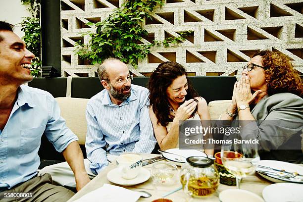 family laughing together during dinner party - 2015 45 50 stock pictures, royalty-free photos & images