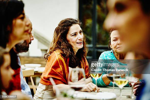 woman in discussion with family during dinner - 2015 45 50 stock pictures, royalty-free photos & images