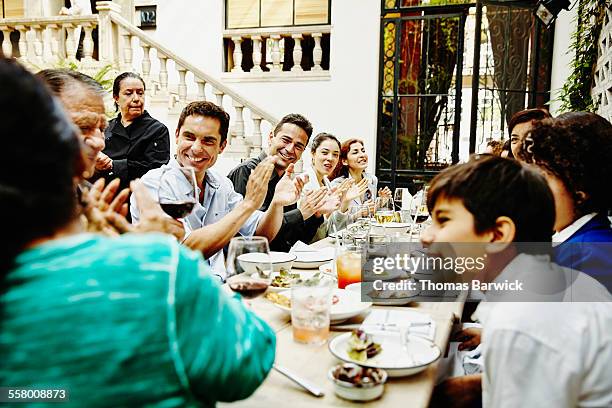 family clapping for grandfather during party - affluent dining stock pictures, royalty-free photos & images