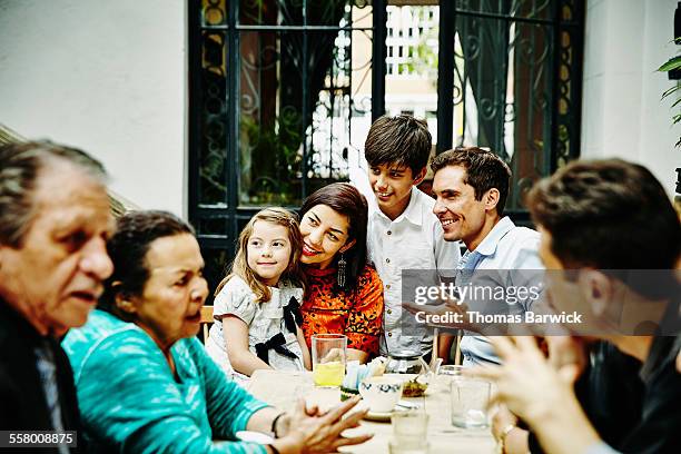 family posing for photo during dinner party - latin america family stock pictures, royalty-free photos & images