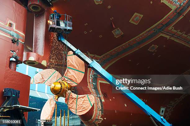 worker working on ship at shipyard, goseong-gun, south korea - astillero fotografías e imágenes de stock