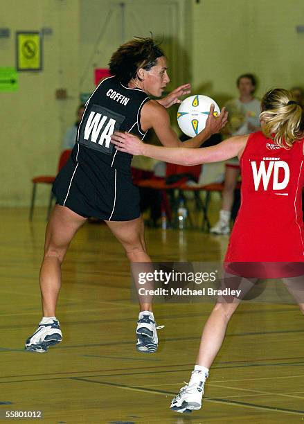 Silver Ferns JennyMay Coffin secures the ball as Welsh player Beverly Lovatt looks on,during the Netball match between the New Zealand Silver Ferns...