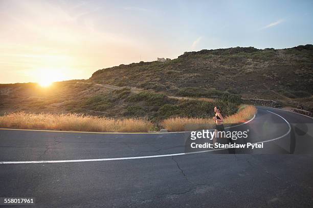 girl on wild road taking curve , sunset - wide stock pictures, royalty-free photos & images