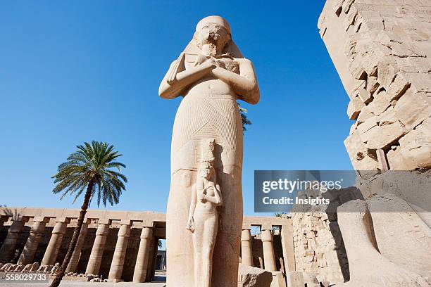 Colossal Statue Of Ramses Ii With A Smaller Figure Of His Queen Nefertari Standing Between His Feet In The Great Court Of The Temple Of Amun In The...