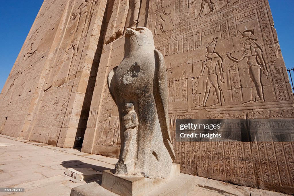 Colossal Black Granite Statue Of Horus As A Falcon In Front Of The Entrance Pylon Of The Temple Of Horus At Edfu, Aswan, Egypt
