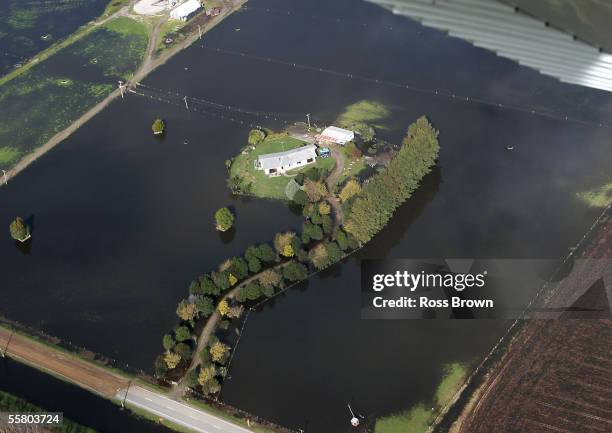 House is almost entirely cut off by surrounding flood water in this aerial view of flooding near Te Puke in the Bay of Plenty, New Zealand, Thursday...