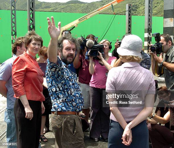 Prime Minister Helen Clark, left, looks on as King Kong movie director Peter Jackson points out to the media part of the New York set built on...