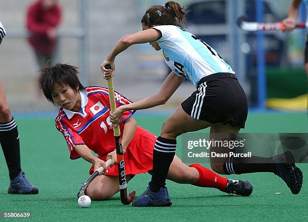 Japan No18 Tomomi Komori competes for the ball with Argentina's Mariana Gonzalez Oliva during the Hockey TriSeries match between Japan and Argentina...