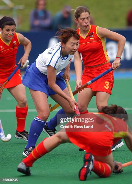 Japans' Sakae Morimoto works her way through the Spanish defence of Ma Carmen Martin , Rocio Ybarra and Marta Prat , during japans' 10 win over Spain...