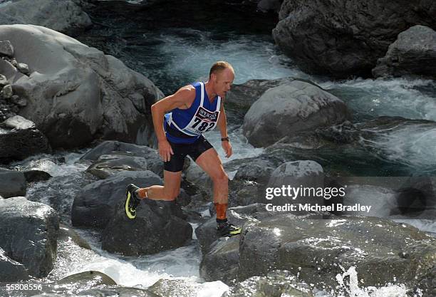 Team member Mark Beasley crosses the boulders as part of the Mountain run stage at the end of the first day of the two day event at the 2004 Speights...