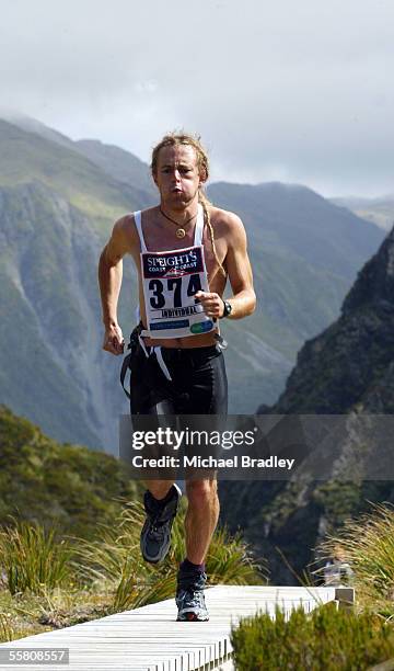 Chris Haslett crosses over goats pass as part of the Mountain run stage at the end of the first day of the two day event at the 2004 Speights Coast...