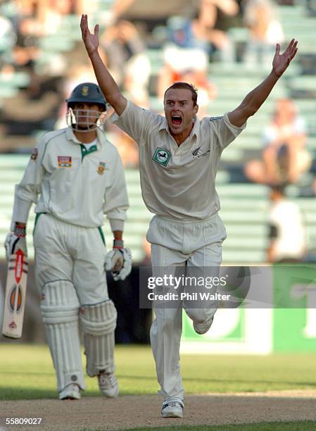 New Zealand's Chris Martin celebrates taking his 10th wicket, South Africa's Mark Boucher, caught by Stephen Fleming for 10 runs on the fourth day of...