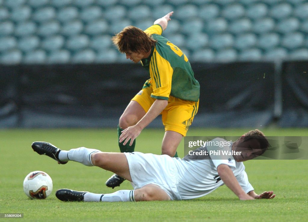 Australia's Brett Holman is tackled by New Zealand