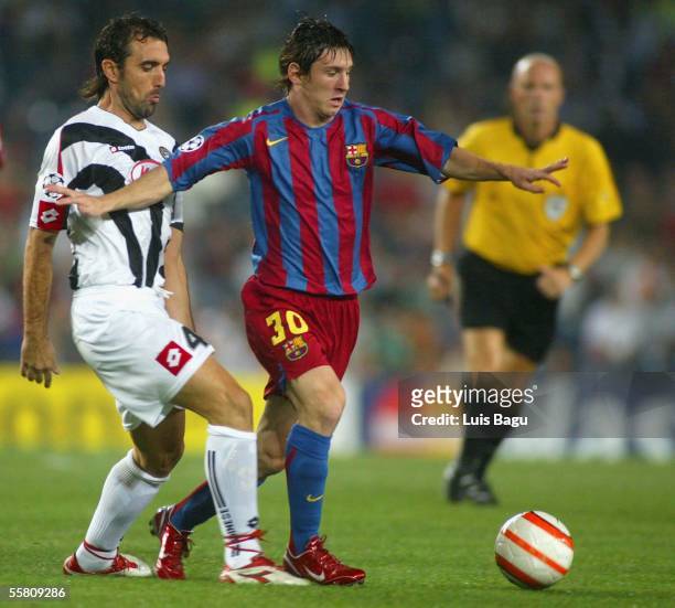 Leo Messi of FC Barcelona and Valerio Bertotto in action during the UEFA Champions League Group A match between FC Barcelona and Udinese played at...