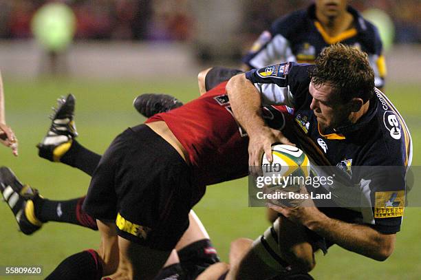 Owen Finegan is tackled by Daniel Carter, during the Crusaders 4728 win over the Brumbies in their Super12 rugby match played at Jade Stadium,...
