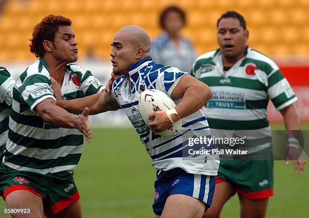 Glenora Bears Caine Nahu fends off Central Falcon's Michael Whakatihi in their Bartercard Cup Rugby League match at Ericsson Stadium in Auckland, New...