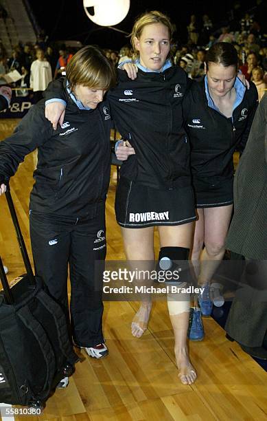 Silver Fern captain Anna Rowberry is helped from the court by phsyio Sharon Kearney and Lesley Nicol after the third and last Fisher and Paykel...
