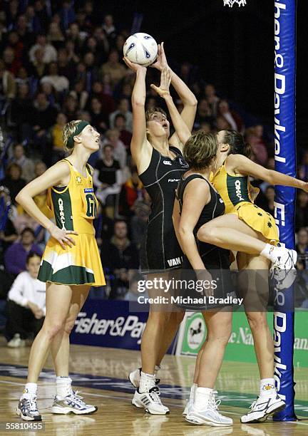 Silver Fern Irene Van Dyk shoots over Australian Liz Ellis as Demelza Fellows and Silver Fern Belinda Colling look on during the third and last...