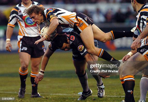 West Tigers Brett Hodgson leaps over the top of Warriors Vinnie Anderson in their NRL Rugby League match played at Jade Stadium in Christchurch, New...