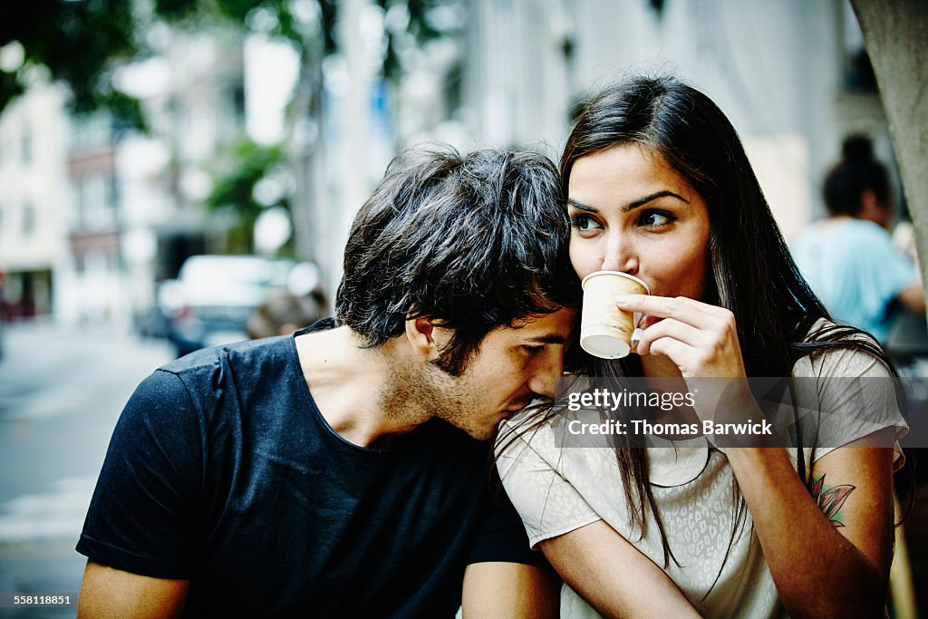 Couple sitting at city cafe drinking espresso