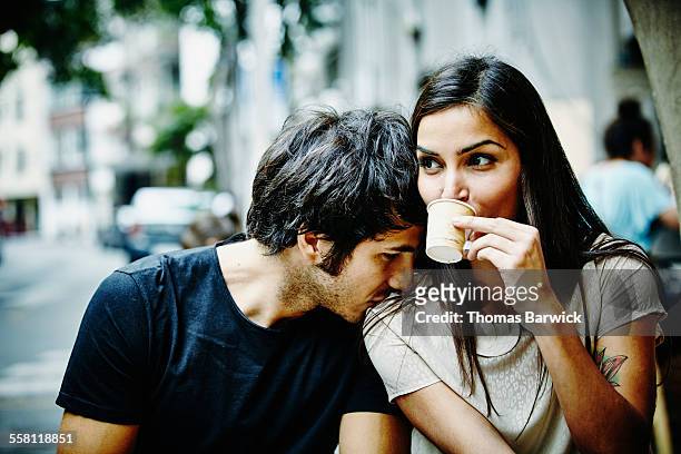 couple sitting at city cafe drinking espresso - red blouse fotografías e imágenes de stock